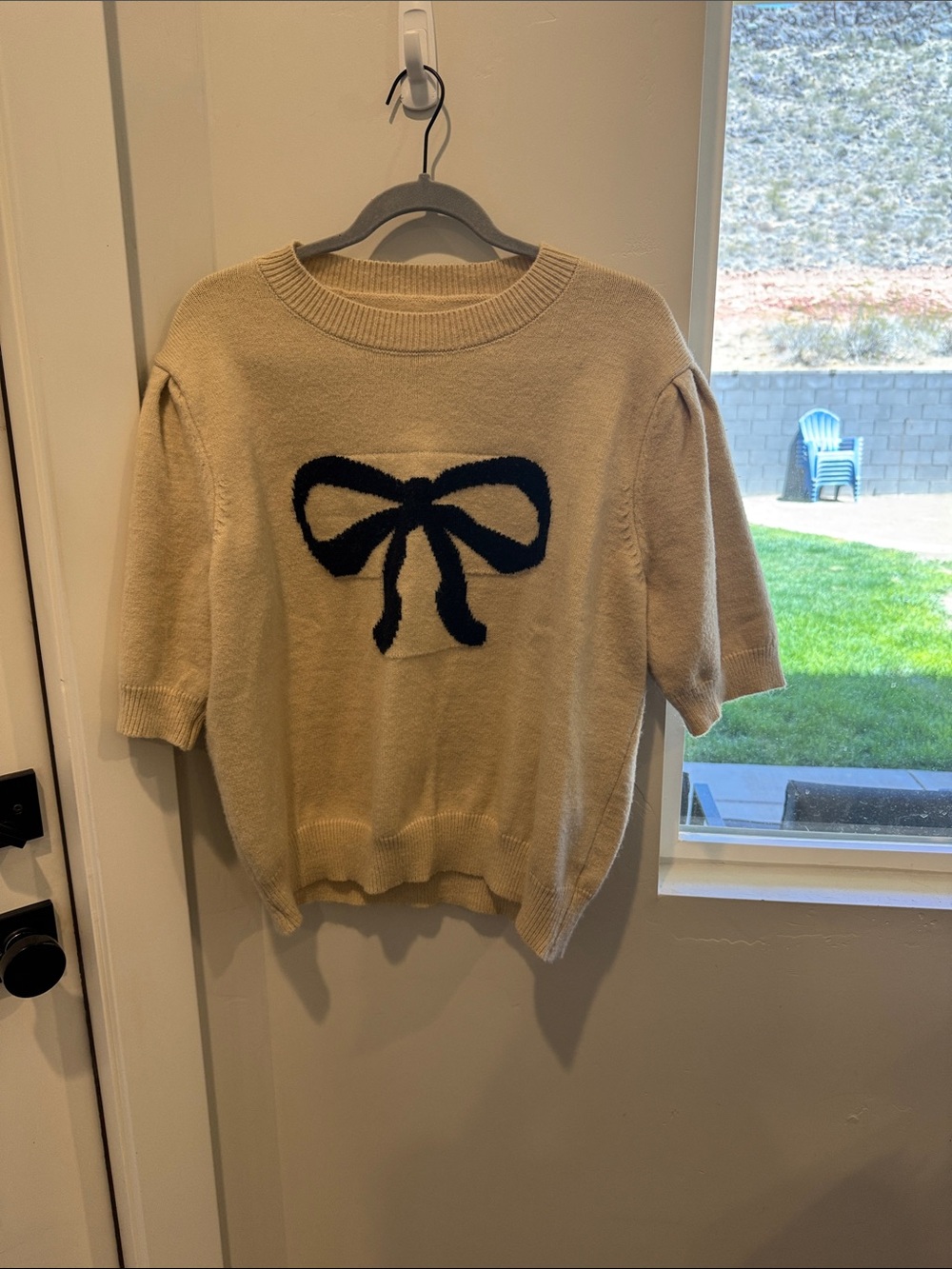 Cream Short-Sleeve Sweater with Black Bow Motif